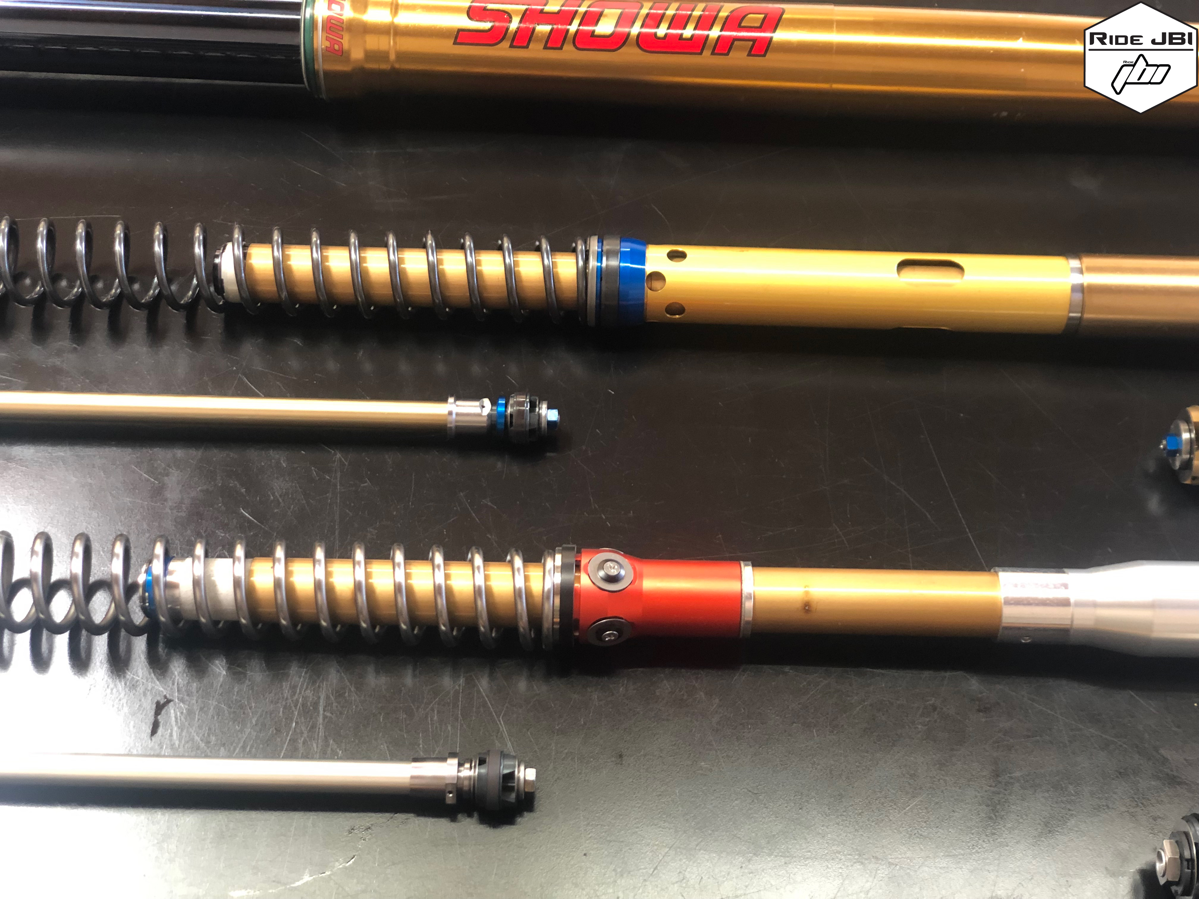 Showa A Kit 49mm Spring Fork next to Showa OEM 49mm Spring Fork Showa A Kit 49mm Spring Fork next to Showa OEM 49mm Spring Fork